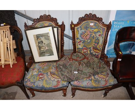 A pair of Victorian walnut nursing chairs upholstered in floral needlepoint tapestry