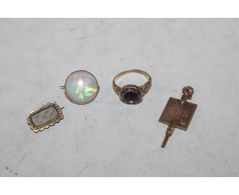 A yellow metal mounted opal brooch, 2.5gms; a yellow metal ring set with red stone, 4.5gms ring size P; an antique yellow met