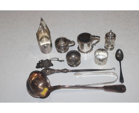 A Henry Wells silver cup holder, a silver napkin ring,  a silver mustard, a silver three piece cruet set, a silver decanter l