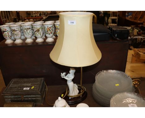A figural decorated table lamp and shade 