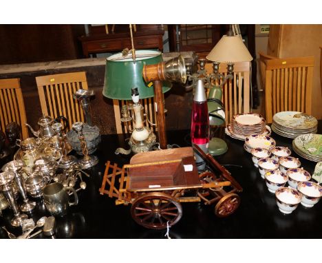 A wooden model of a cart; a lava lamp; an adjustable desk lamp; various other table lamps and a brass candelabra 