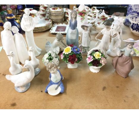 A collection of assorted ceramic figurines including NAO royal Doulton etc.