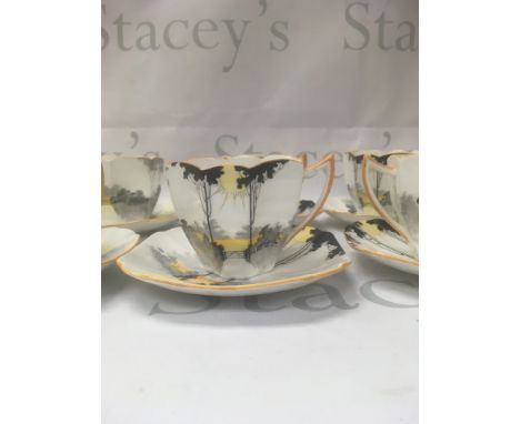 A set of eight Shelly cups and saucers Tall trees sunset pattern.