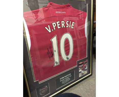 A framed and singed Robin Van Persie Arsenal shirt.