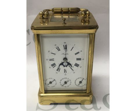 A brass carriage repeat clock with Roman numerals Subsidiary dial day and month having a moon roller inset 14 cm .