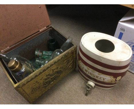 A brass coal box containing various glassware including ships in bottles, cod bottles etc plus a ceramic whiskey barrel (2). 