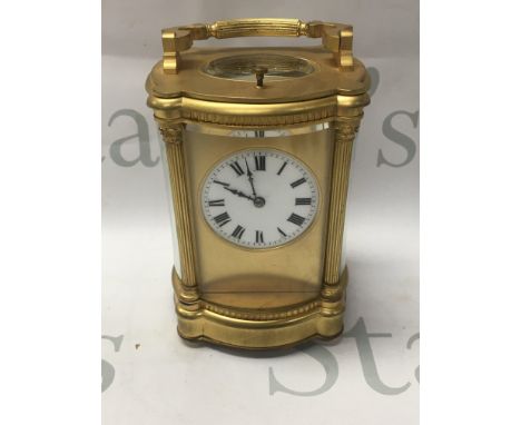 A gilt carriage clock the dial with Roman numerals button repeat movement 14 cm .