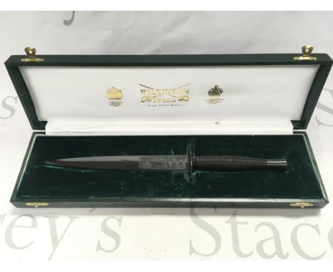 A cased Wilkinson sword anodised black Fairbairn Sykes commando style dagger , 29cm long. This lot cannot be posted