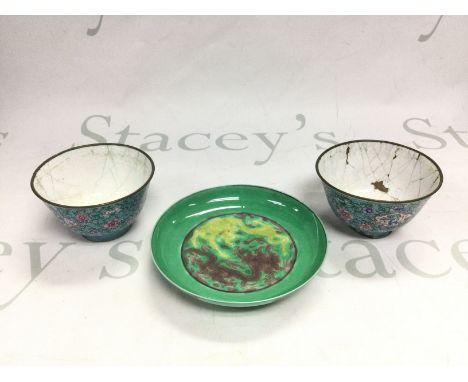 Two enamel tea bowls and an Oriental ceramic dish decorated with dragons, approx width 12.5cm (3). Shipping category D.
