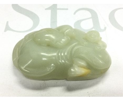 A jade buckle carved with a horse and monkey, approx width 8.5cm. Shipping category A.
