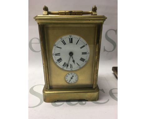 A gilt case carriage clock the dial with Roman numerals repeat button movement 13 cm .