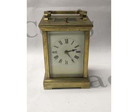 A brass carriage clock the dial with Roman numerals repeat button movement 12 cm .