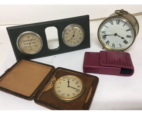 A brass cylinder cased table clock a traveling clock in a fitted case a desk top clock barometer and a modern Dunhill leather