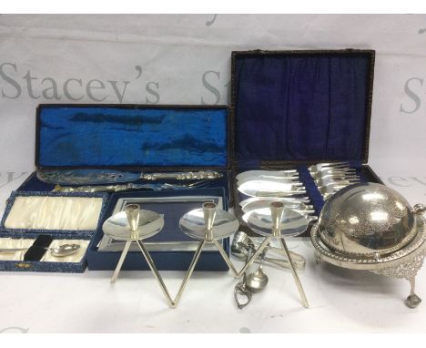 A box of silver plated items comprising a Danish modern design three branch candelabra, three entree dishes, wine coasters, s