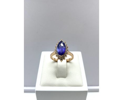 A 14ct rose gold marques tanzanite &amp; diamond ring, weight is 5.3 grams approx, size L