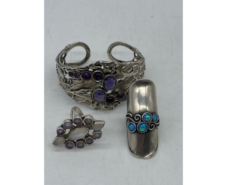 A mixed lot of silver, a bangle and 2 x rings, 57 grams in weight approx