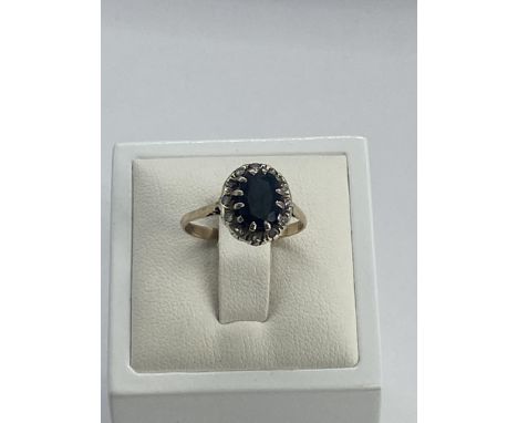 A 9ct yellow gold diamond and sapphire dress ring, size M, 2.4 grams in weight approx