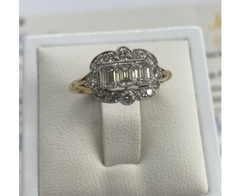 An 18ct yellow &amp; white gold cluster diamond ring, emerald cut diamonds are 0.49ct diamonds, round brilliant cut diamonds 