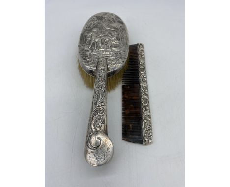 A silver 1890s brush set,9 1/2 inches x 3 1/2 inches wide brush, beautifully decorated, comb is 7 inches long x 1 1/2 inches 
