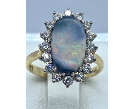 An 18ct yellow gold Opal &amp; diamond ring, size K,    Austalian Opal , 13mm x 8mm size stone, stone is surrounded by 16 dia