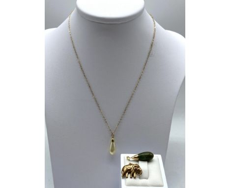 A mixed lot of 9ct &amp; 14ct yellow gold, including jade pendant is 14ct, elephant charm and a synthetic pearl pendant, weig