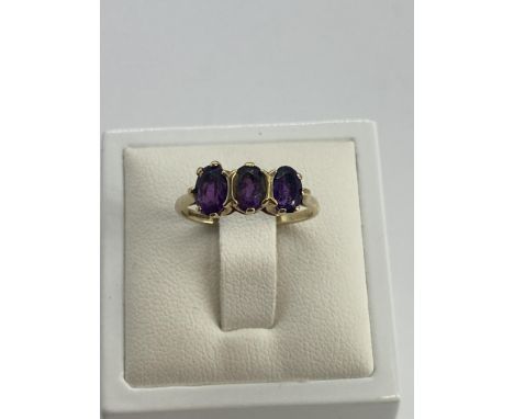 A 9ct yellow gold 3 stone amethyst dress ring, size M, weight is 2 grams approx