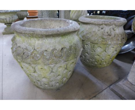 A pair of concrete garden planters