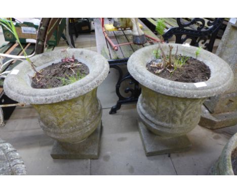 A pair of concrete garden urns