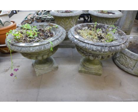 A pair of concrete garden urns