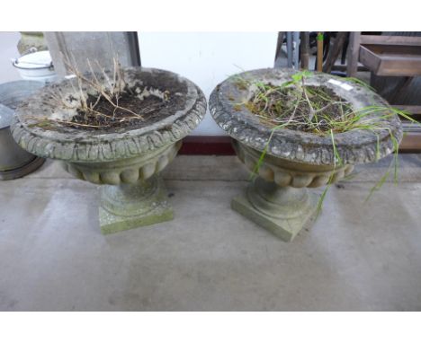 A pair of concrete garden urns