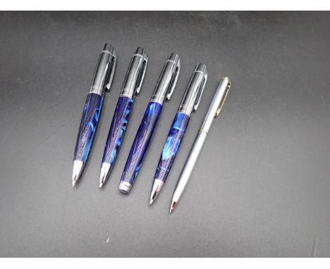 A Sheaffer Fountain Pen, two Ballpoints and a Propelling Pencil with blue cases, and another Sheaffer Propelling Pencil 