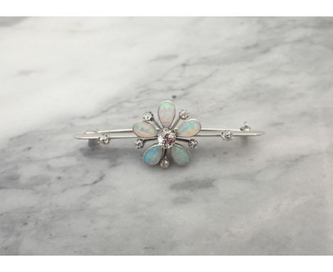 A Diamond and Opal Flower Brooch claw-set old-cut diamond within five pear shaped opal cabochons and five old-cut diamonds se