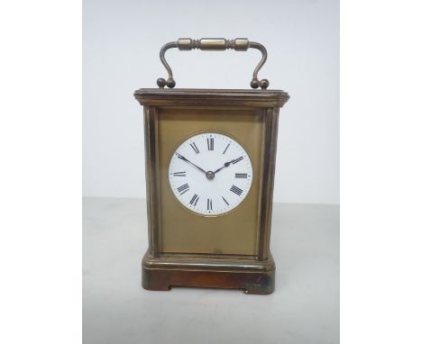 A French brass cased Carriage Clock with white enamel circular dial, lever escapement, striking on coil, 7in, No 5908 