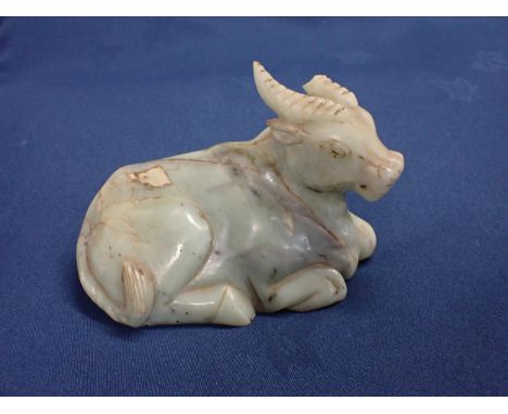 An Oriental jade type recumbent Buffalo, 6in, A/F 