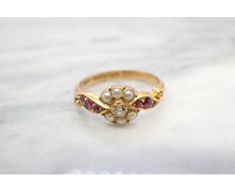 A 19ct Century Diamond, Seed Pearl and Ruby Ring claw-set old-cut diamond within frame of seed pearls, trios of round rubies 