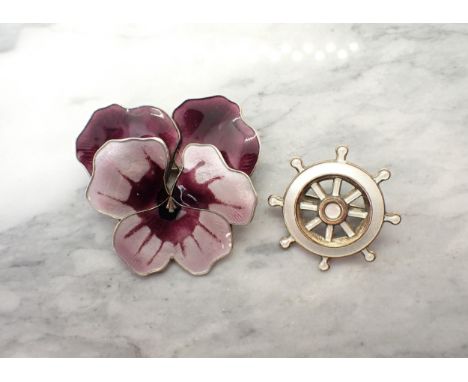 A David Andersen, Norwegian sterling silver with purple enamel 'Pansy' Brooch, 48mm wide and a Ship's Wheel Brooch in cream e