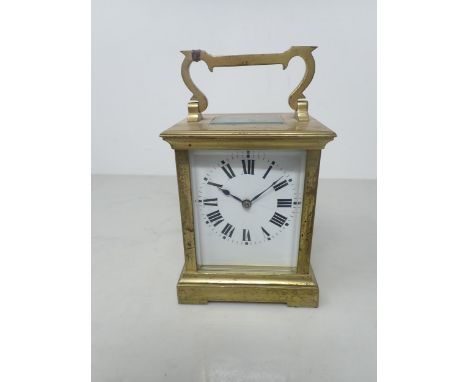 A French brass cased Carriage Clock with white enamel rectangular dial, lever escapement striking on coil, 6¼in 