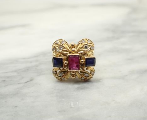 A Ruby, Sapphire and Diamond Cocktail Ring rubover-set step-cut ruby and two step-cut sapphires between pavé-set eight-cut di