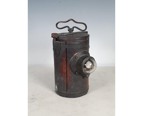 An "Edison &amp; Swan Company Safety Lamp, Ponders End", London, with brass handle and bulb to the front, housed in a metal c