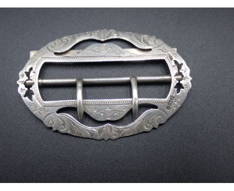 A Victorian silver Nurse's Buckle of oval form with scroll engraving, Birmingham 1900, maker: K &amp; C 