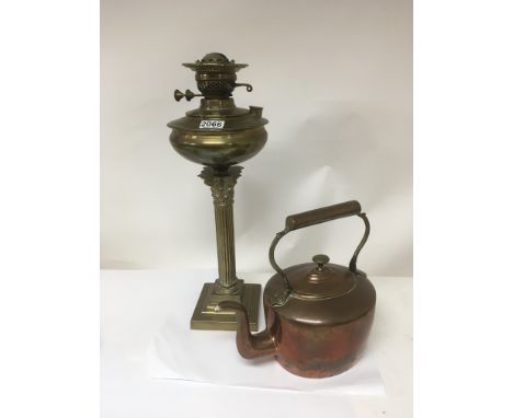 A brass Corinthian column oil lamp and a copper kettle (2)