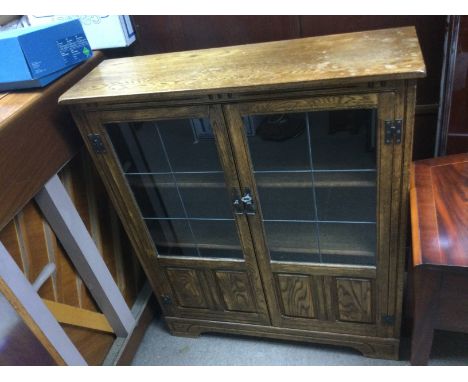 An oak bookcase with lead light doors, approx 93cm x 29cm x 111cm.
