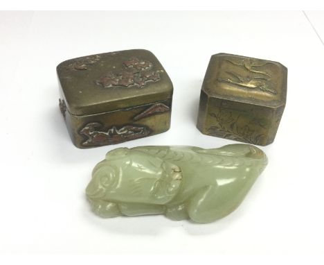A small jade figure of a dragon, approx length 8cm, plus two small brass boxes (3). Shipping category B.