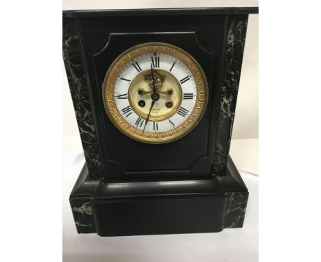 A Victorian French black slate and marble mantel clock the dial with visible pendulum the movement striking on a bell and wit