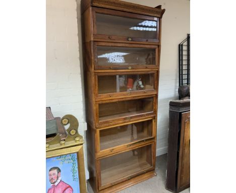 A 1940s Utility oak Lebus sectional bookcase, 220 x 88cm