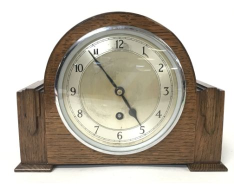 An oak mantle clock by Garrard with chrome key and pendulum
