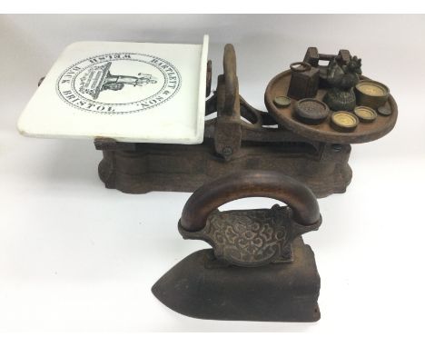A vintage set of grocer's scales, various weights and a Victorian iron. Shipping category D.