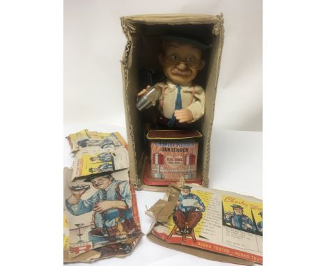 A Vintage boxed Tin plate Charley Weaver the bar tender in a box torn cover.