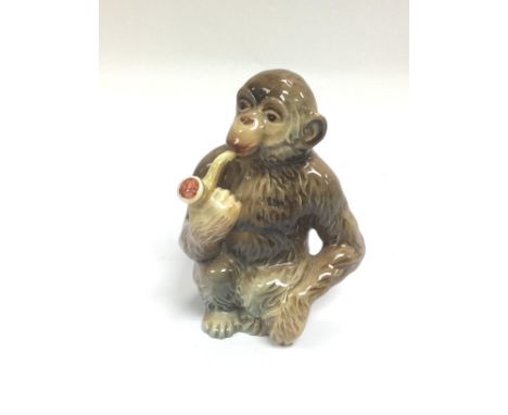 A Beswick figure of a monkey smoking a pipe, approx height 11.5cm. Shipping category D.