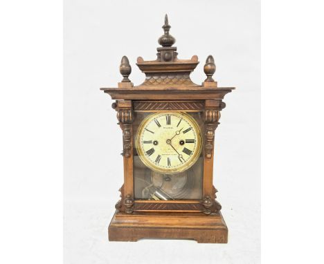 19th century wooden case mantle clock made in Wurttemberg Germany and sold by R.A. Jones Southend, working order with key and